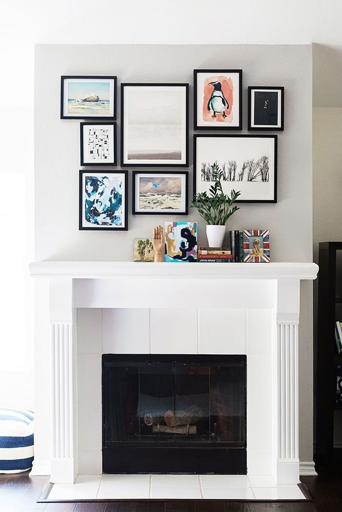Organized gallery wall of framed art displayed above a fireplace