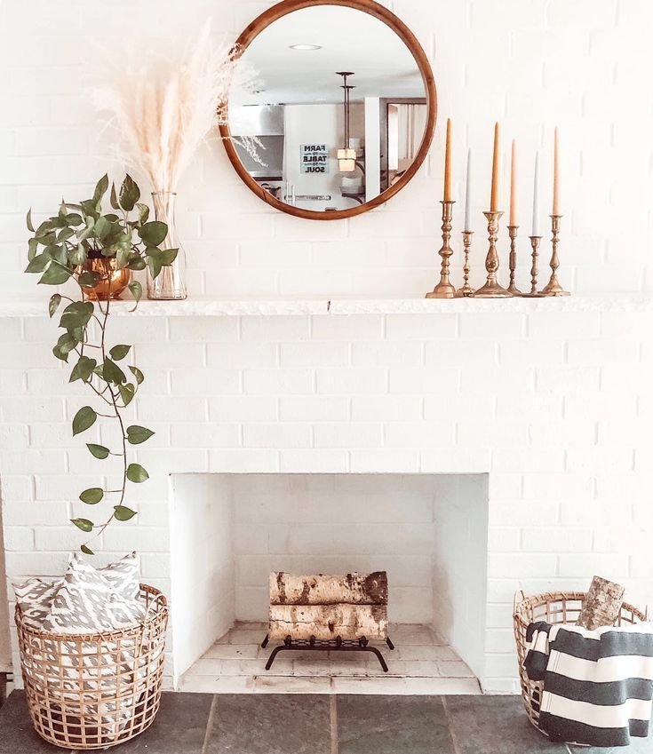 Slimline mirror hung above a fireplace to reflect light into the room