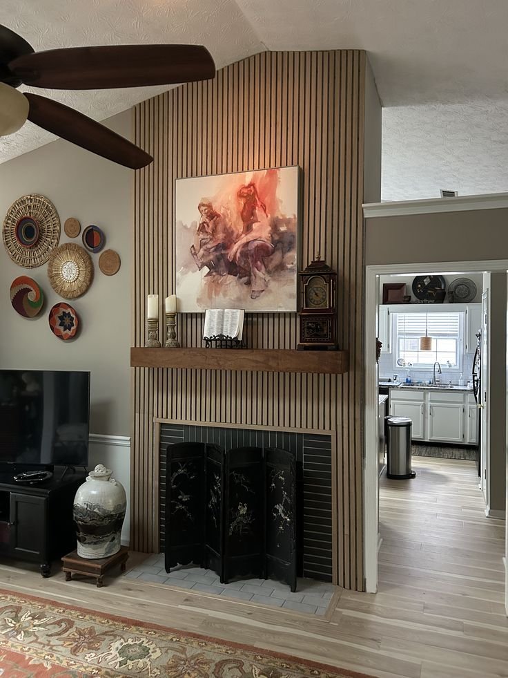 Textured wood wall panels installed behind a fireplace feature