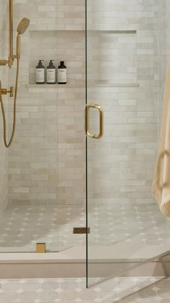 Bathroom wall with bold patterned statement tile against otherwise simple white fixtures