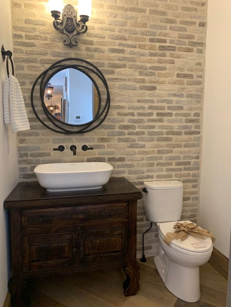 Bathroom wall with ribbed textured tile catching light at an angle