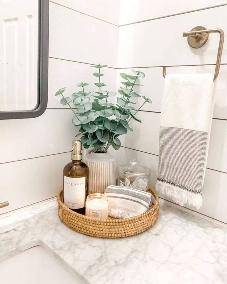 Everyday bathroom items displayed in glass containers