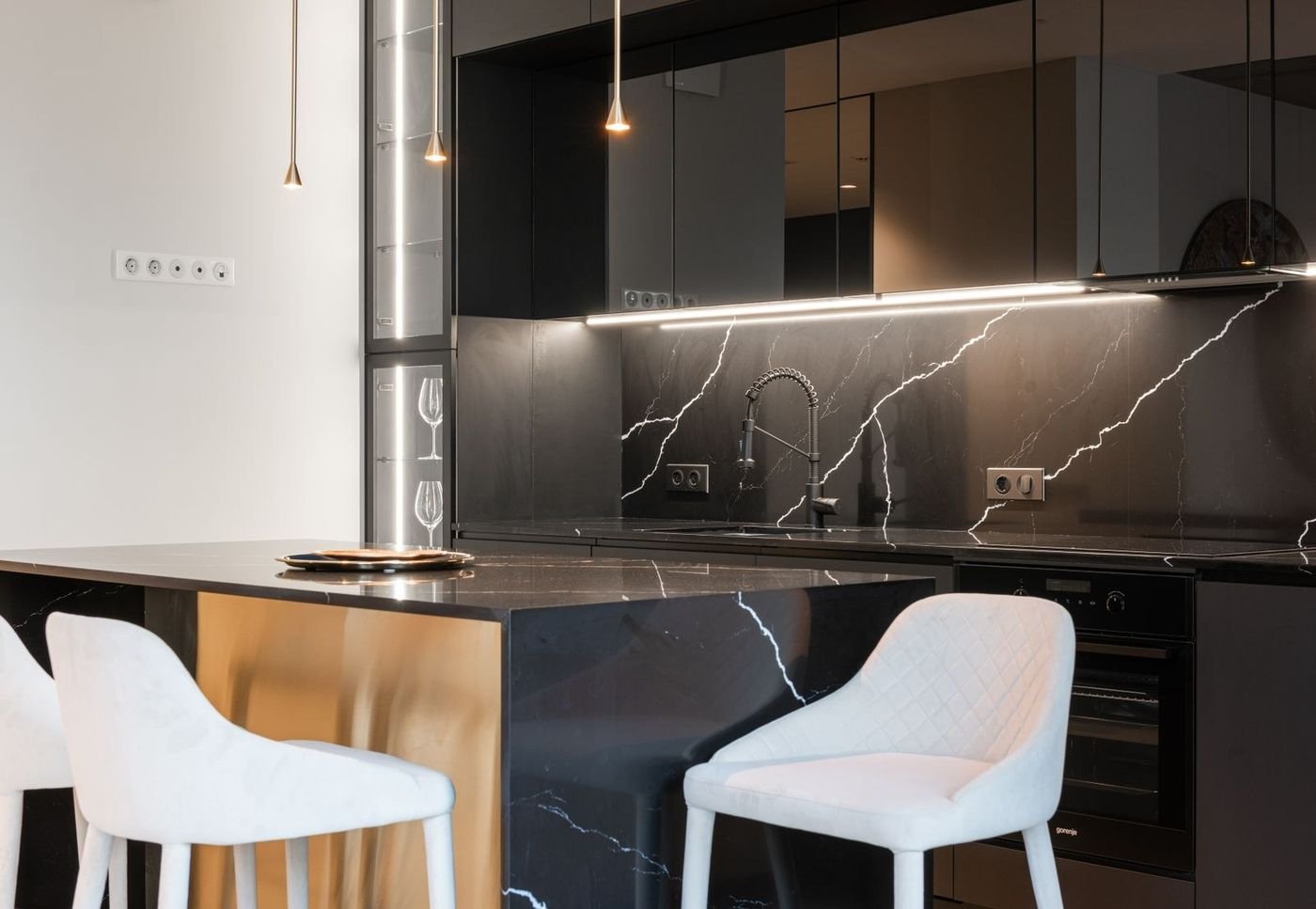 Sleek black kitchen interior with bold cabinetry and warm accents
