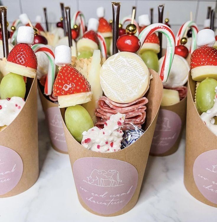 Holiday-themed charcuterie cup with cranberries and rosemary