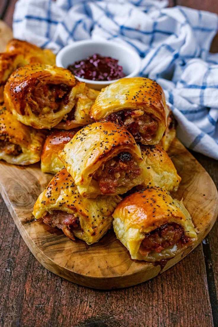 Mini sausage rolls with a poppy-seed glaze and cranberry sauce