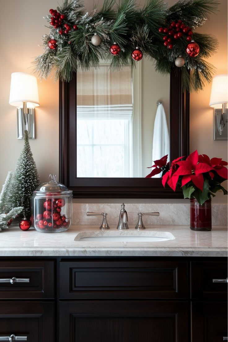 Garland and ornament swag draped over a dark framed bathroom mirror with a poinsettia