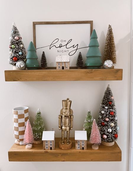 Layered bathroom shelves with a gold nutcracker and bottle brush Christmas trees
