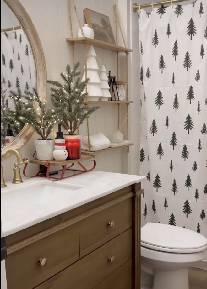 Pine tree print shower curtain with a styled sled tray on the vanity