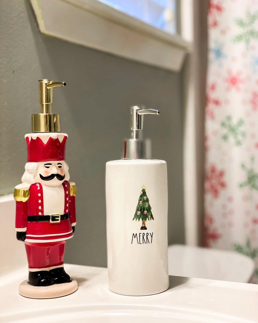 Nutcracker figurine next to a Merry soap dispenser on a bathroom counter