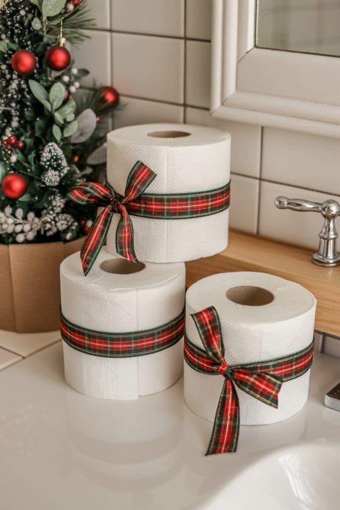 Toilet paper rolls wrapped with red and green plaid bows