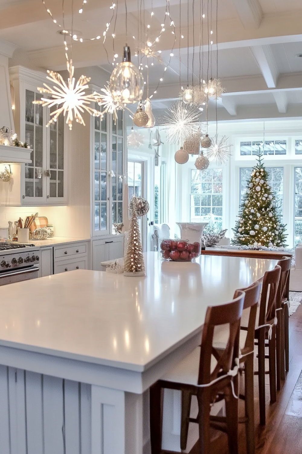 Snowflake and ornament pendant lights hanging over a white kitchen island