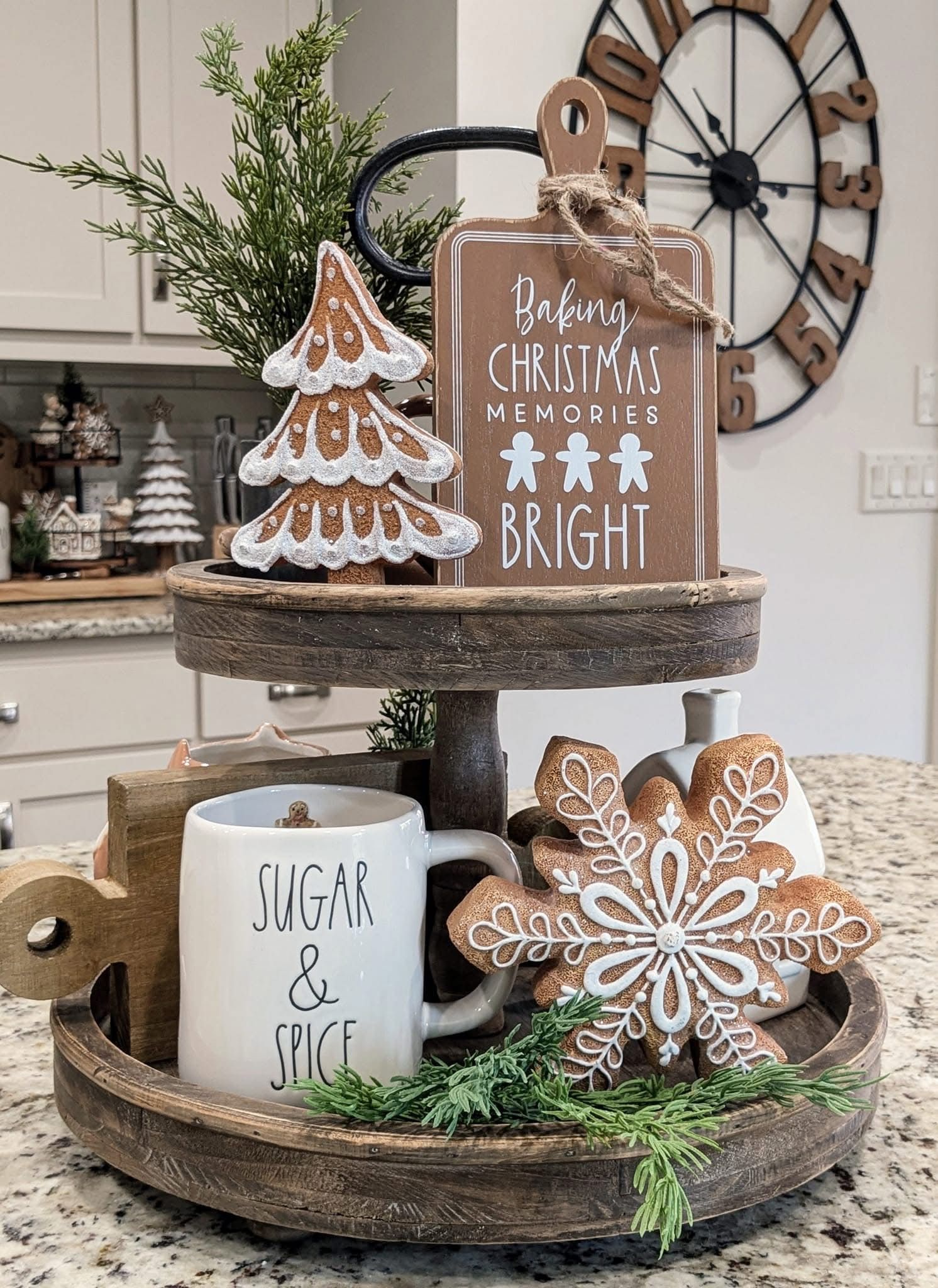 Three-tier galvanized metal tray with a gingerbread house and cookies