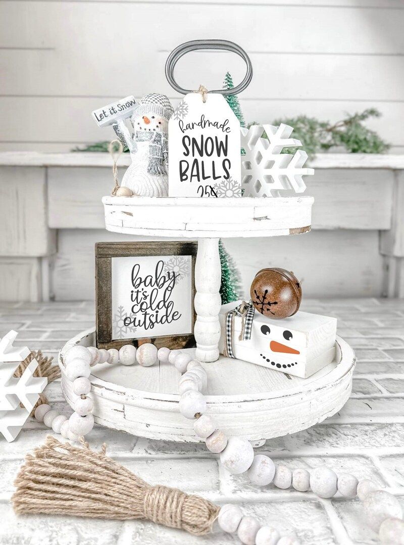 Tiered tray with a handmade Snow Balls 25 cents sign and wood bead garland