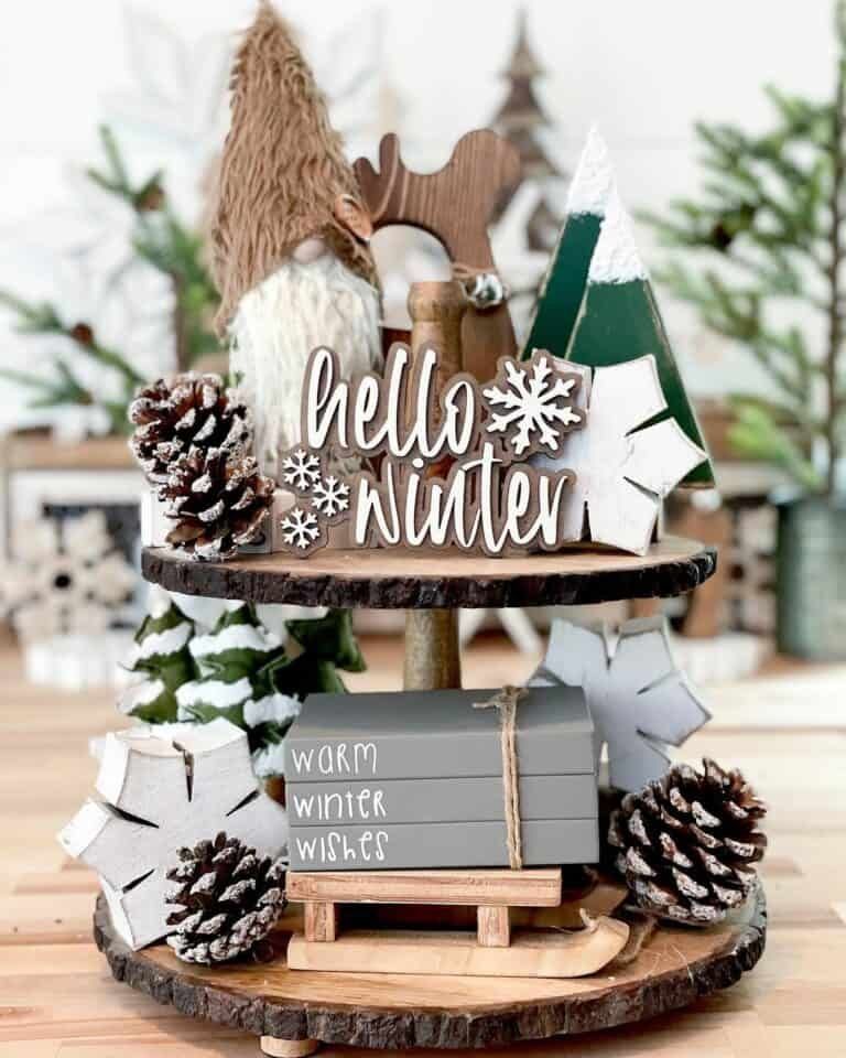 Tiered tray with a tall gnome figurine and a Hello Winter wood sign