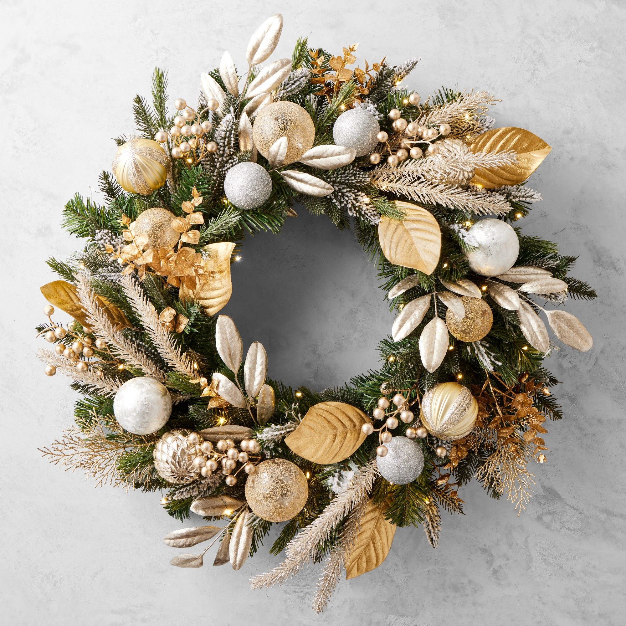 Gilded champagne ornament wreath with gold leaves and string lights