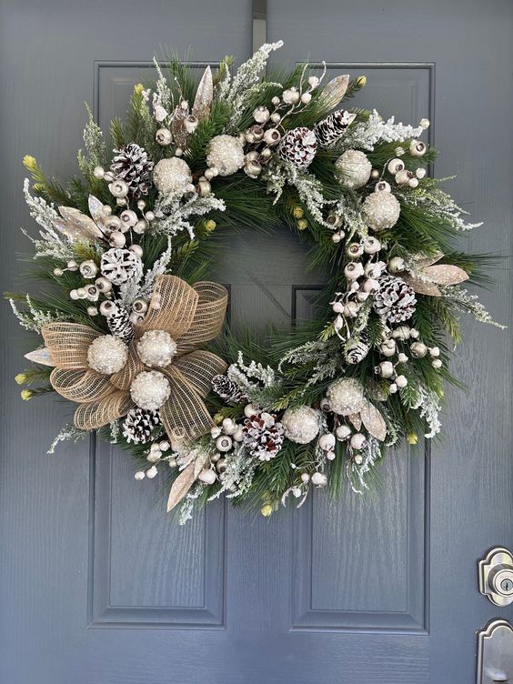 White and silver Christmas wreath with a burlap mesh bow