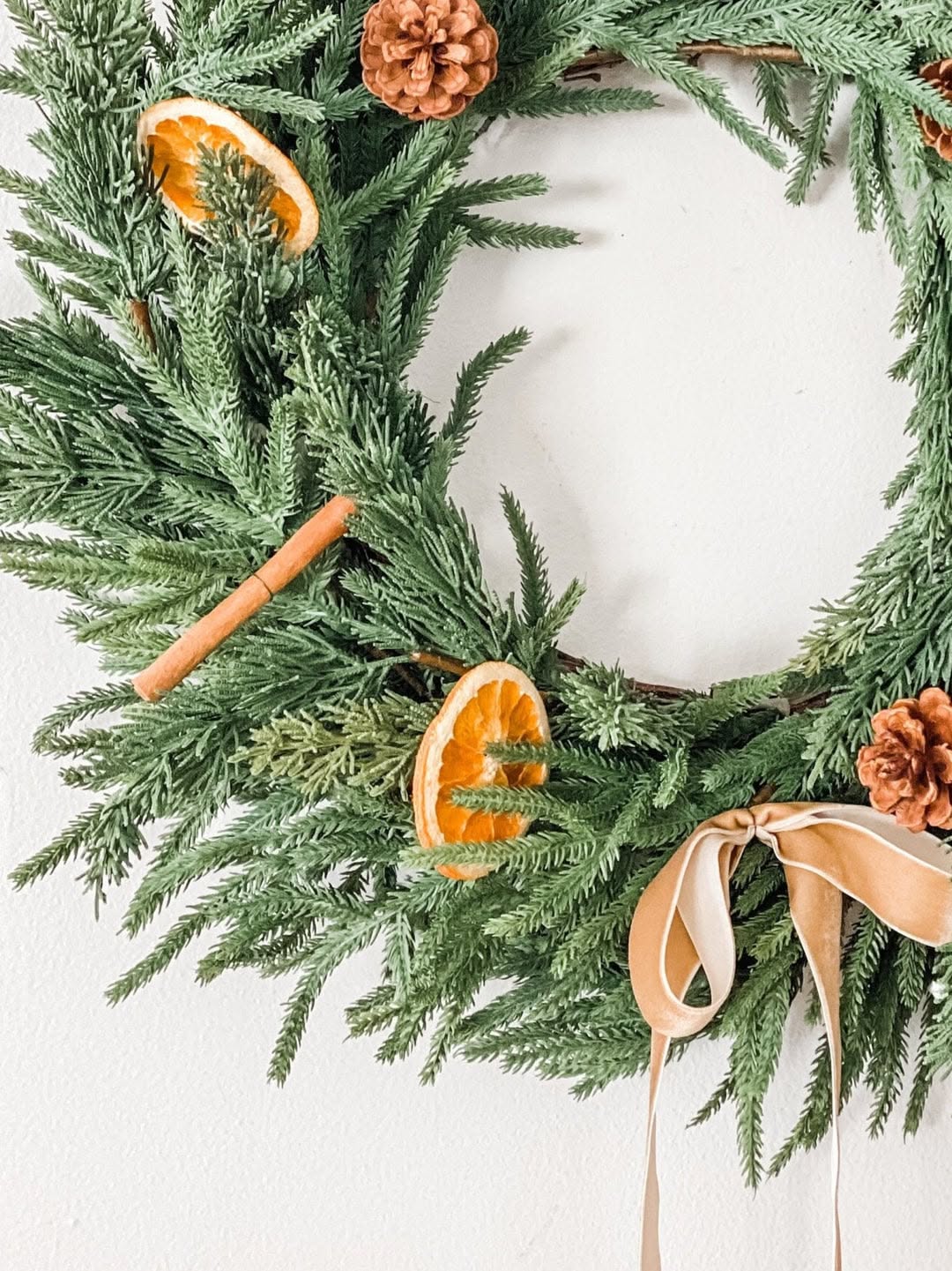 Pine wreath with dried orange slices and a cinnamon stick