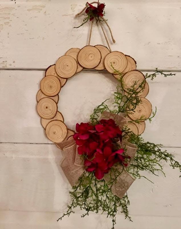 Wood slice wreath with a red hydrangea and burlap bow