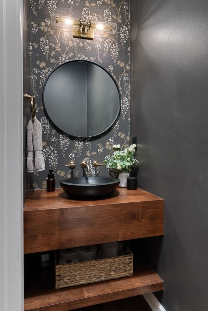 Dark and moody powder room remodel with rich, luxurious finishes