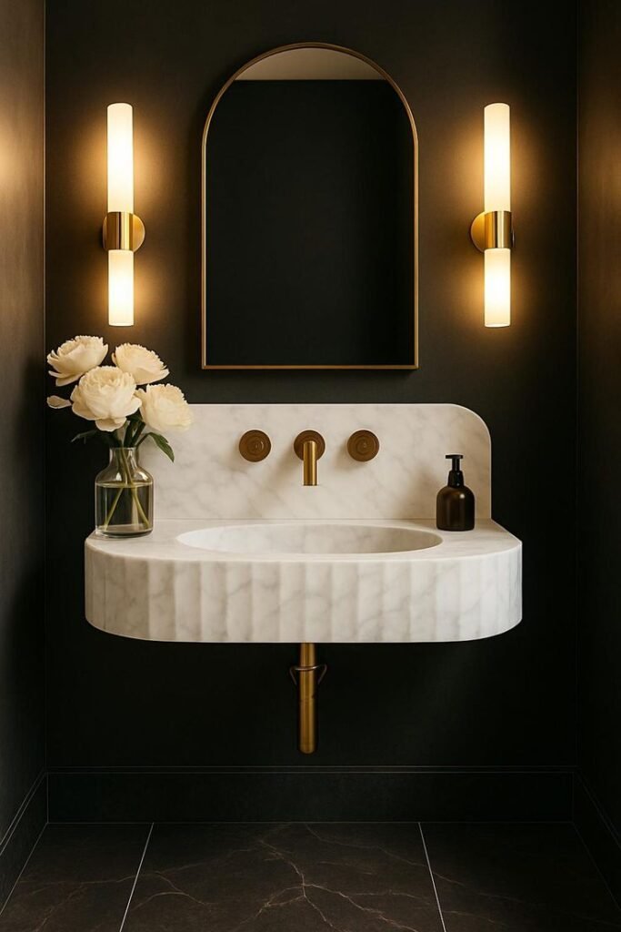 Handmade Carrara marble wall-mounted sink in a bespoke luxury bathroom