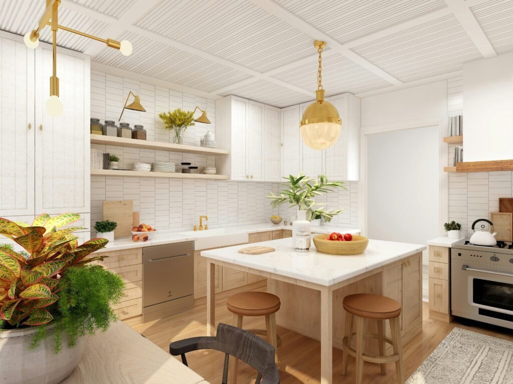 Cream and white kitchen with a large island, brass pendant lighting, wood bar stools and layered greenery