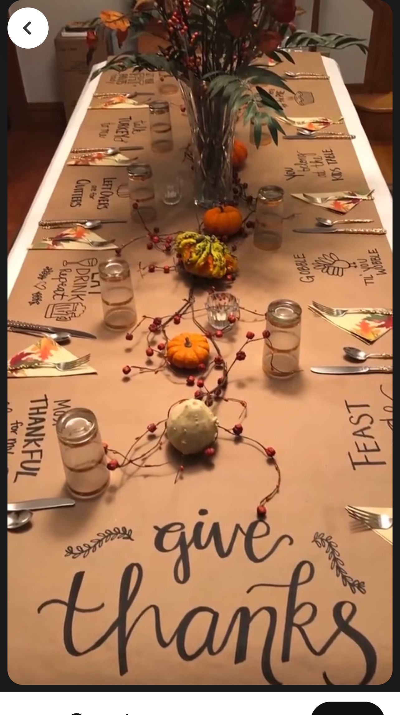A kraft paper table runner with hand-lettered funny Thanksgiving sayings at each place setting
