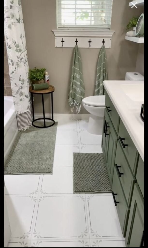 Green towels and soft textiles adding color to a neutral bathroom