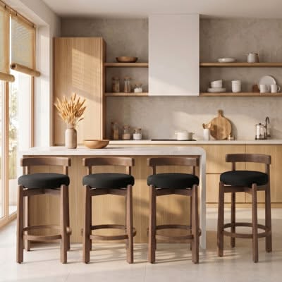 Kitchen island with four black-upholstered wood counter stools in front of open shelving styled with ceramics