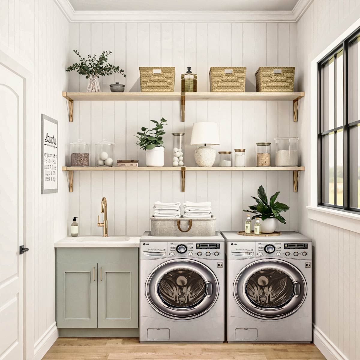 Farmhouse laundry nook with sage green cabinetry, floating shelves and a woven basket topped washer and dryer