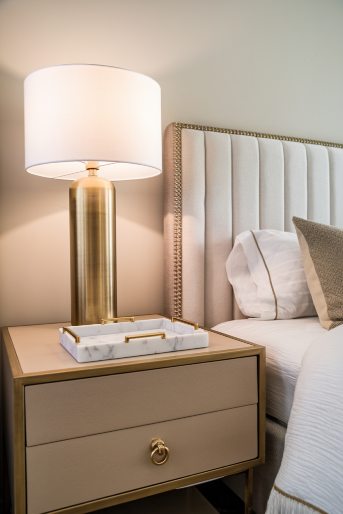Metallic accents catching light throughout the bedroom