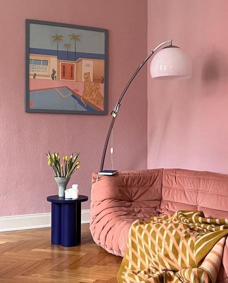 Single pink accent wall in an otherwise neutral living room
