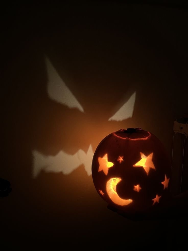 Sleepy face with closed eyes carved into a pumpkin with stars