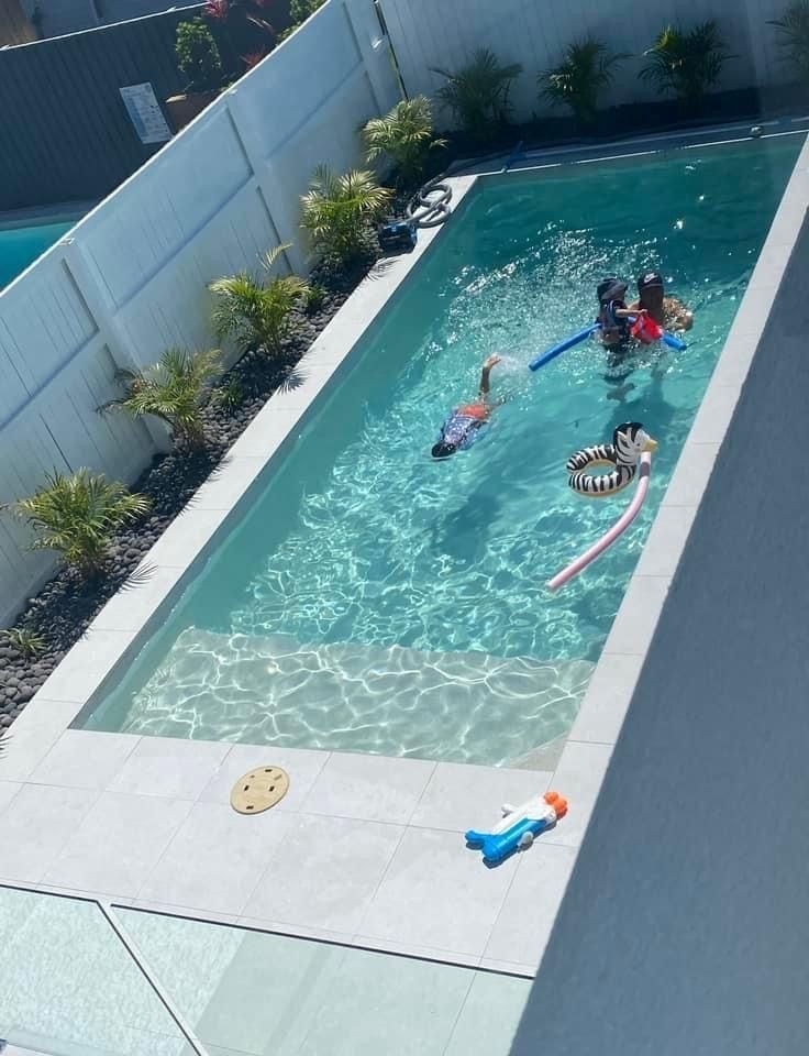 Narrow lap pool stretching the length of a small backyard