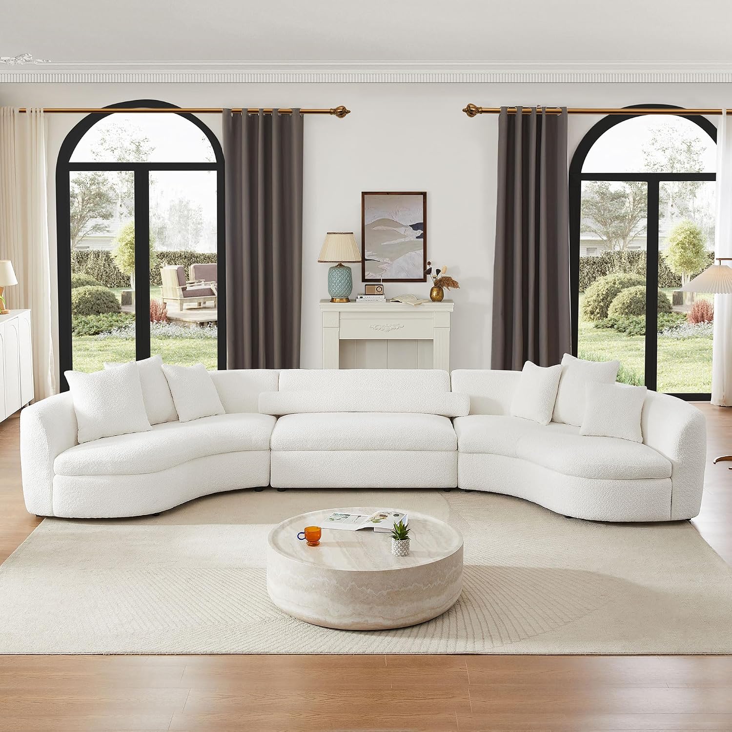 White bouclé curved sectional sofa in a bright living room