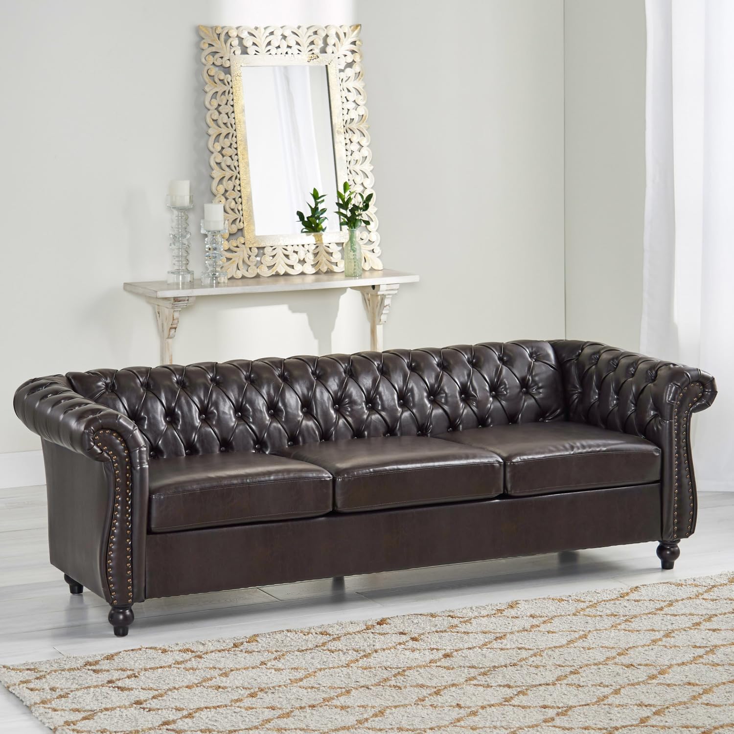 Chocolate brown tufted sofa with rolled arms in an elegant living room