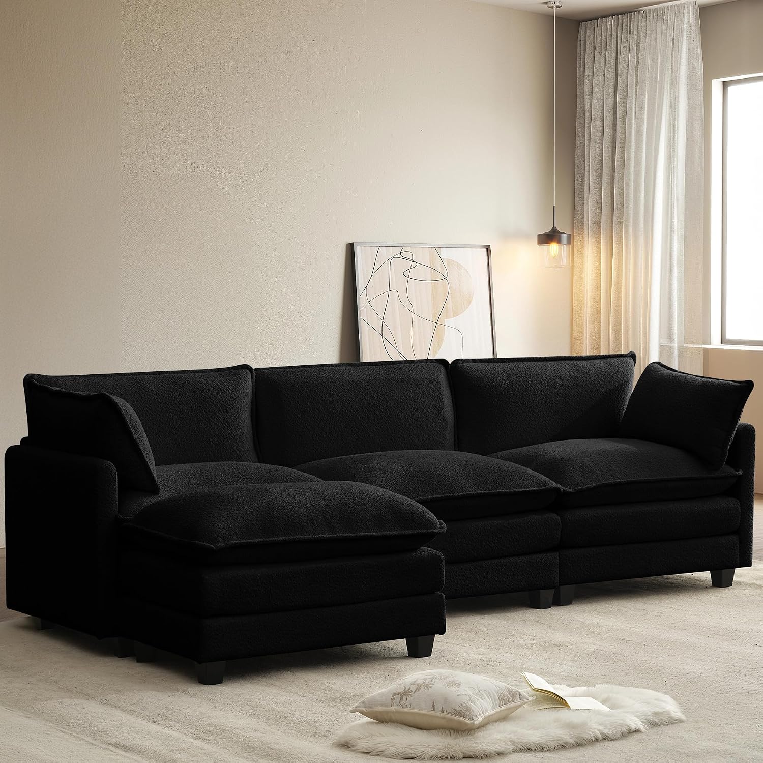 Black modular cloud sectional with a movable ottoman in a minimal living room