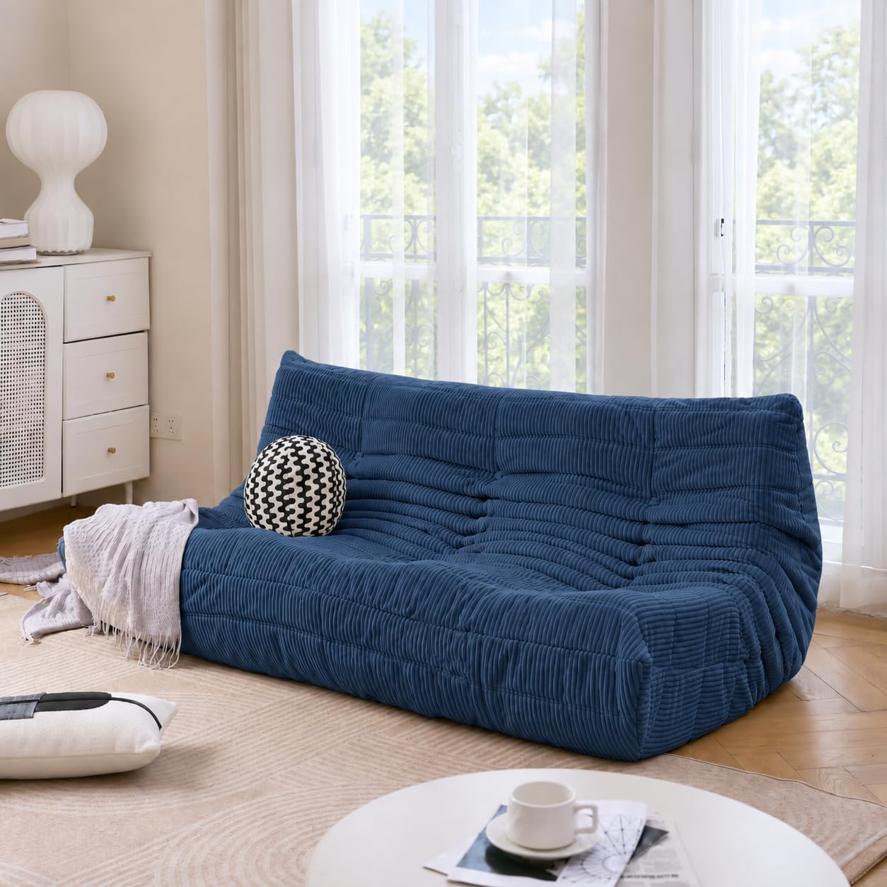 Deep navy blue sofa styled as a bold living room color choice