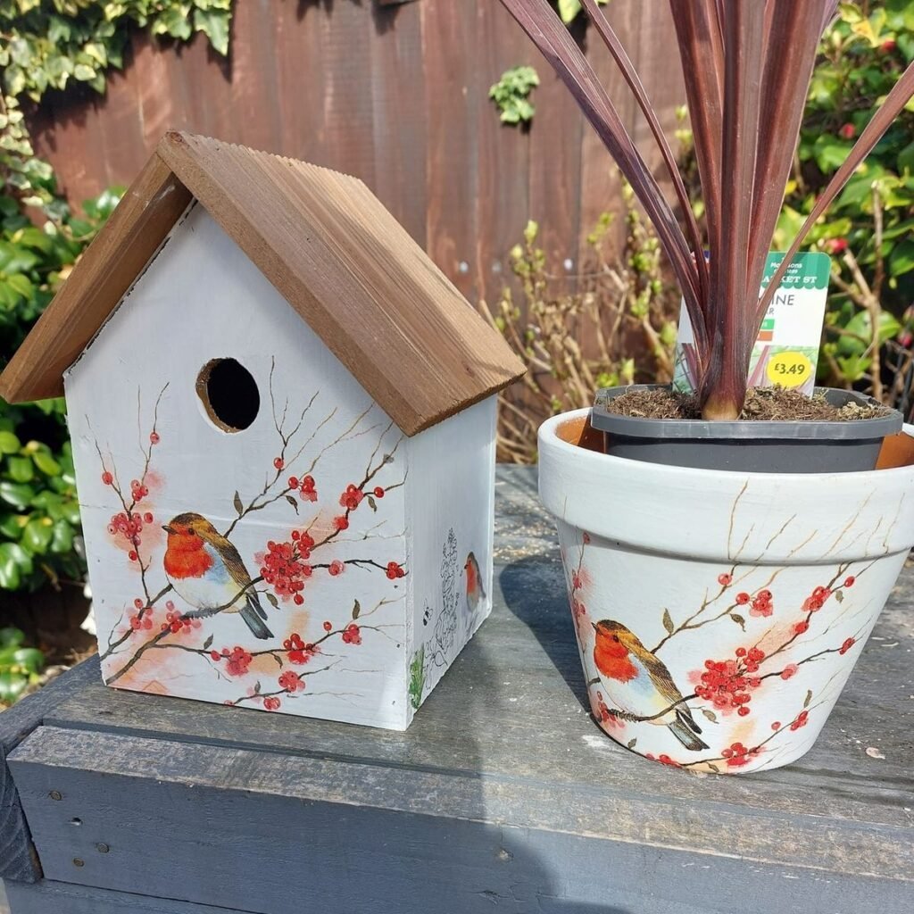 Painted terracotta birdhouses in soft pastel colors styled on a shelf