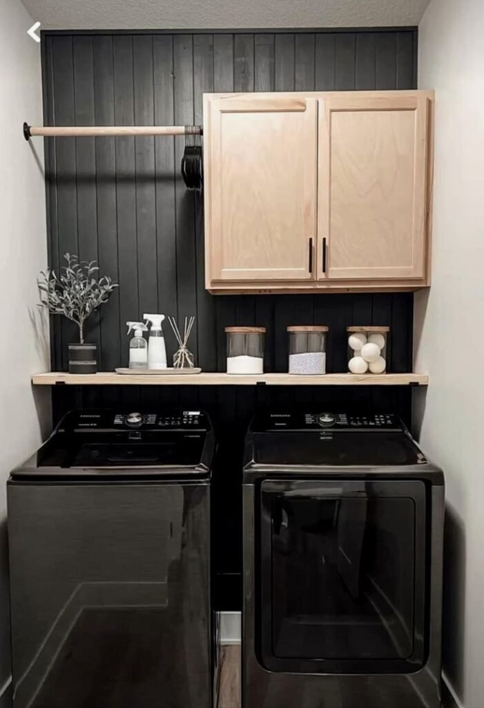 Moody dark stacked laundry room with matte black hardware