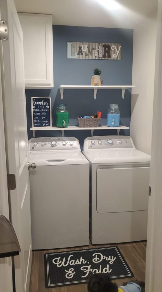 Stacked laundry machines fitted into a narrow hallway setup
