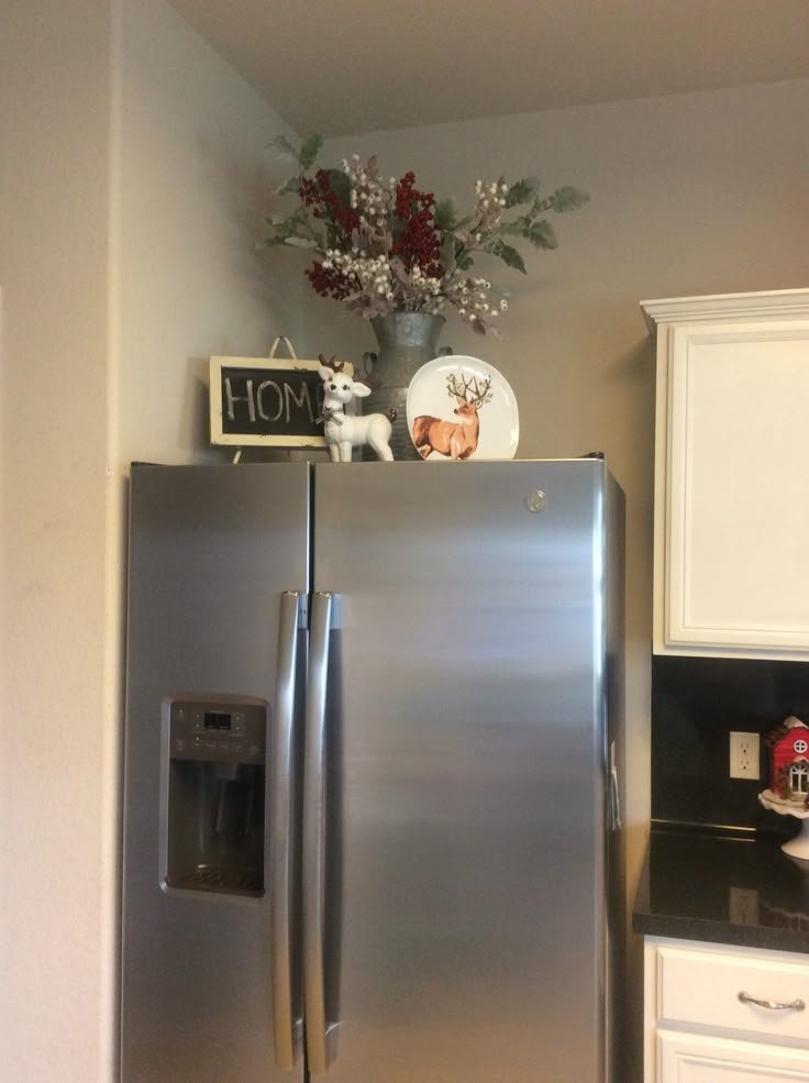 Top of fridge styled with a chalkboard sign and deer figurines