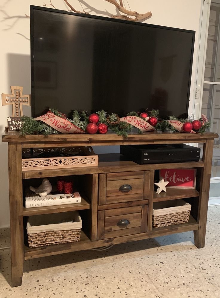 Hidden storage baskets keeping clutter off a styled TV stand