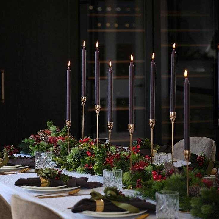 Dark charcoal candlesticks and chargers contrasting a light winter table
