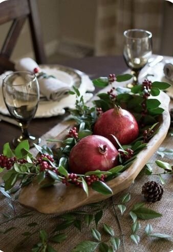 Seasonal fruit like pomegranates and oranges used as winter table decor