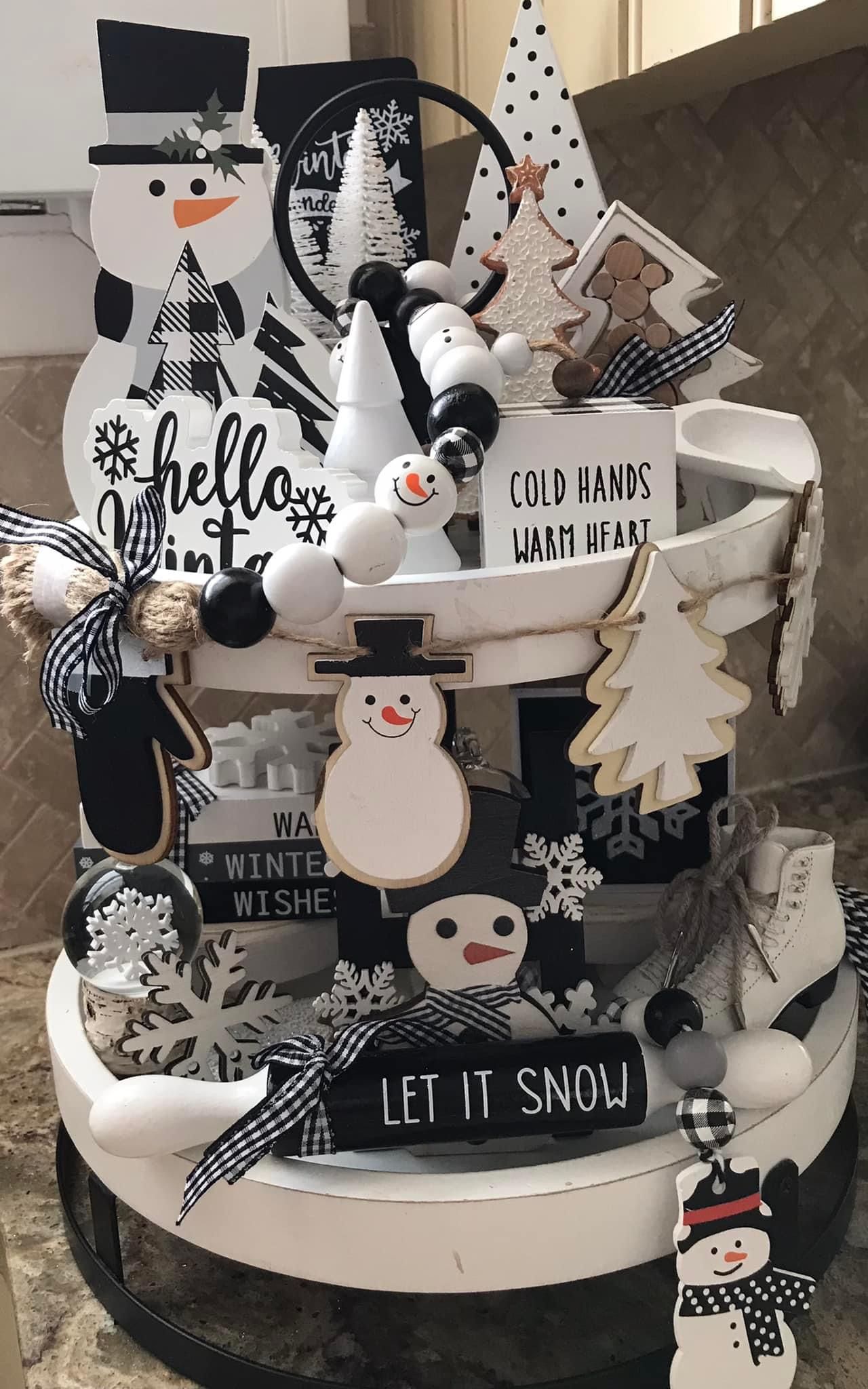 Black and white tiered tray with snowman decor and a bead garland