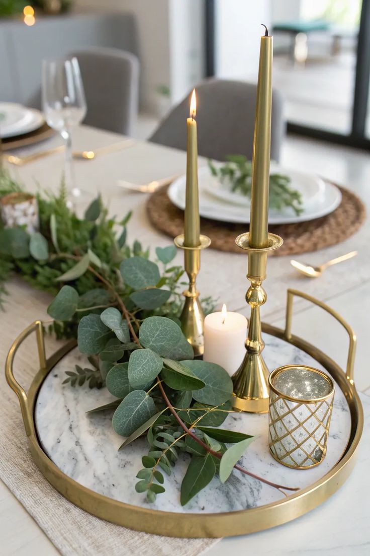 Gold tray with brass candlesticks and mercury glass votives