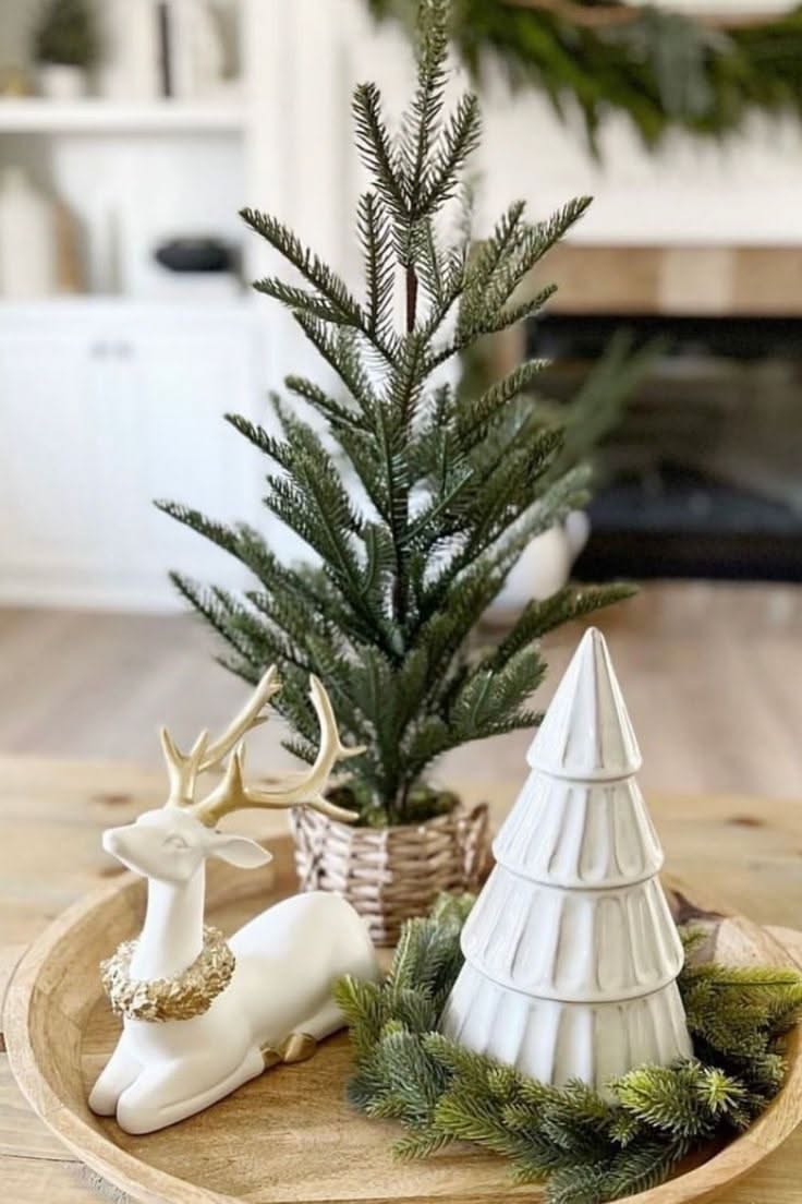 Wood tray with a white ceramic deer and a small tiered tree